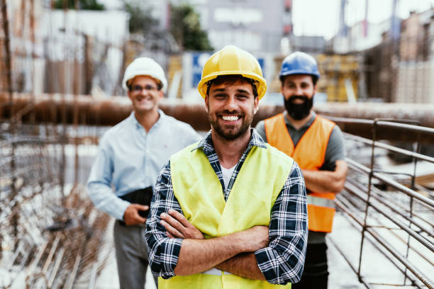 istock Engineers on construction site, looking at camera and smiling. Employment during recession 1455690587
