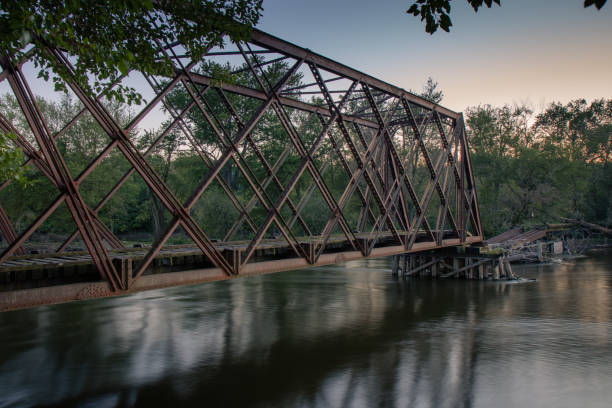 istock Old rusty bridge above the river at sunset 1455690888