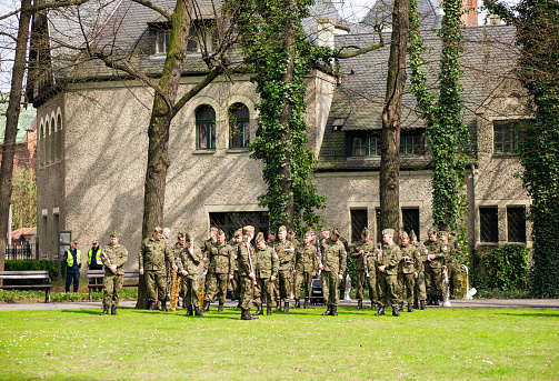 Poznan, Poland – April 13, 2018: A group of soldiers attending a ceremony in the garden of the Imperial Building in Poland
