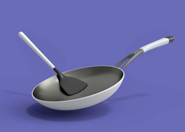 istock Frying pan with glass lid and silicon solid turner on violet background. 1455691317