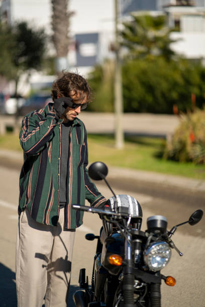 istock Handsome guy near a motorcycle motorist posing in fancy clothes 1455692041