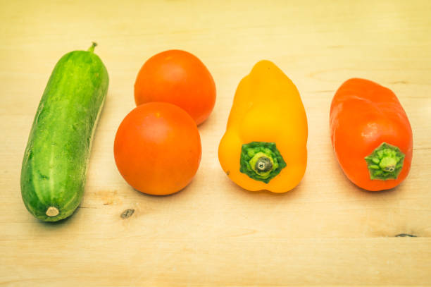 A number of colorful vegetables in a kitchen on a table