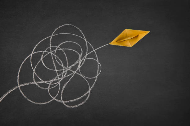 istock Paper Boat Sailing out of Tangled Path 1455693048