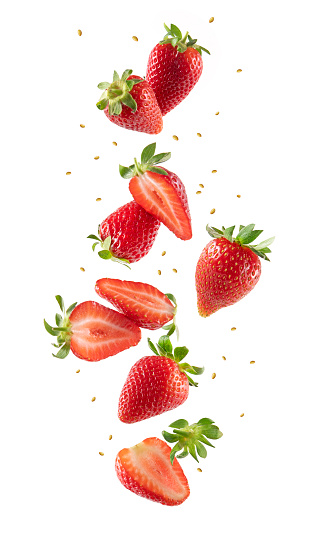 Whole and sliced strawberries in the air isolated on white background