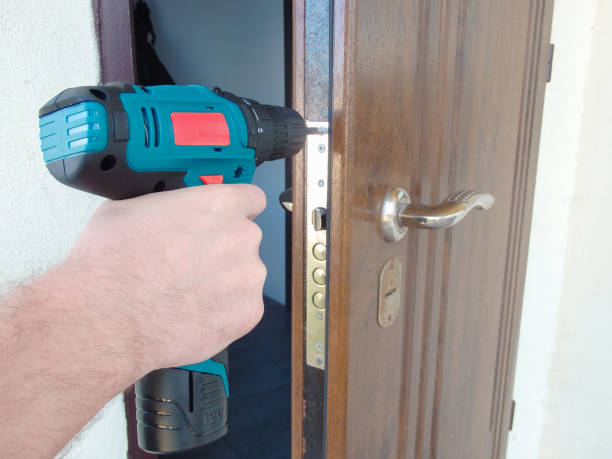 istock Hand 's man with screwdriver. The worker using an electric drill screwdriver, close-up. Concept of repair and construction services. 1455694708