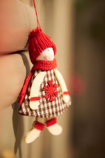 A festive handmade Santa Claus-themed doll made of felt, showcasing intricate details and a cheerful appearance. Features include bright eyes, a curly beard, and a red and white hat, evoking holiday spirit.