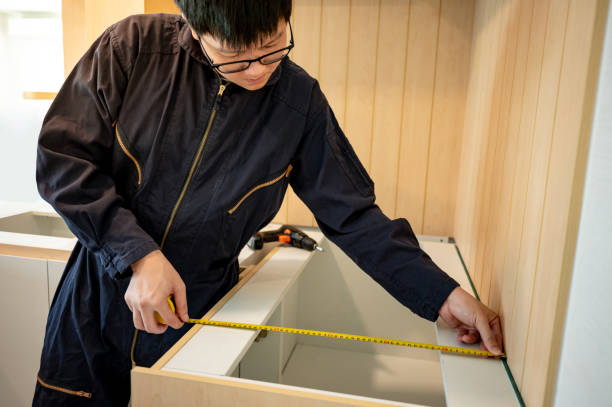 istock Asian male furniture assembler using tape measure 1455696172