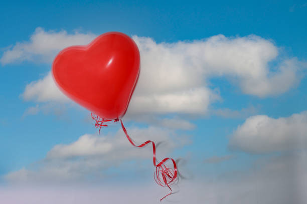 istock A red air balloon heart lies on sky image 1455696447