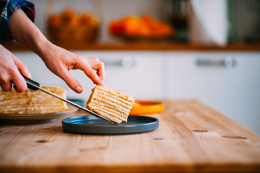 Woman Serving Medovik Cake