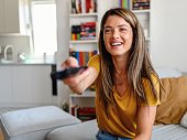 Woman enjoying her favorite TV show at home