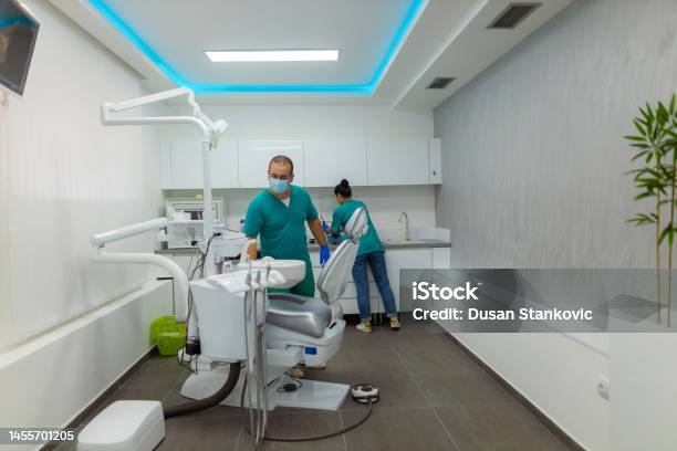 Dentists Cleaning The Dental Tools Stock Photo - Download Image Now - 30-34 Years, Adult, Adults Only