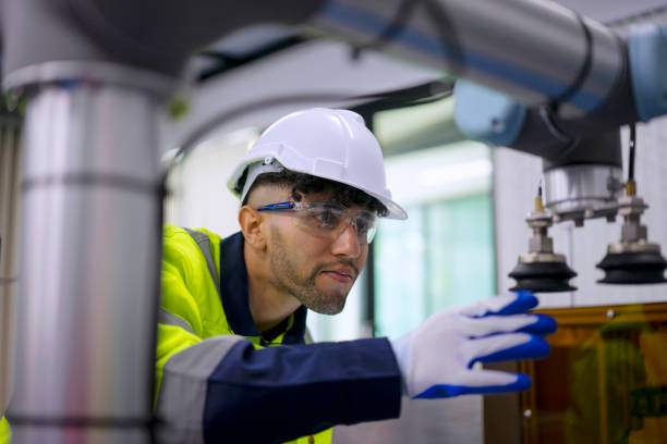 Technician work with robotic arm. stock photo