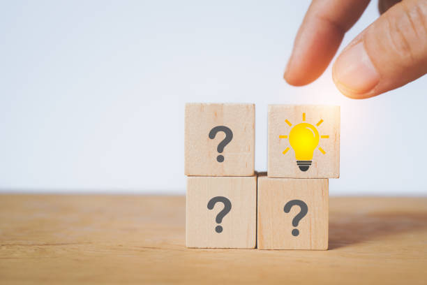 istock hand choose brighten lightbulb on wooden cube block for smart idea, brainstorming, solution concept 1455703014