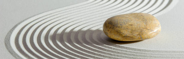 istock Japanese zen garden with stone in textured sand 1455703318