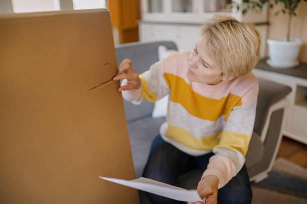 istock A woman looking at the damage on her delivery box 1455703538