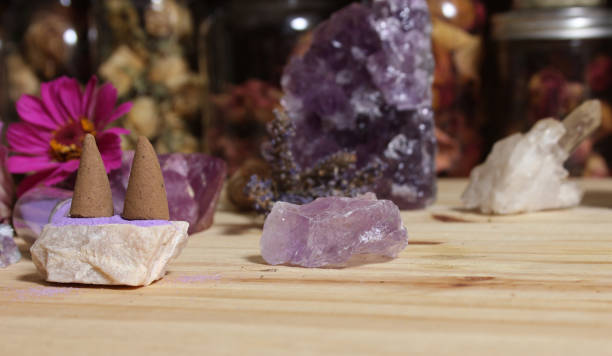 istock Amethyst Crystals With Flowers and Incense Cones on Meditation Table 1455704716