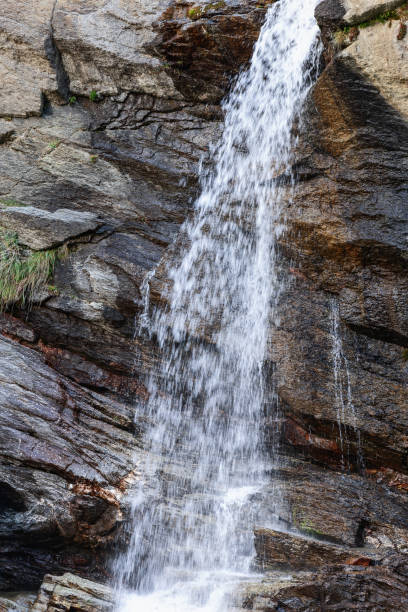 istock Falling water jets from Lillaz waterfall (Cascate di Lillaz) over alpine karst geological formations. Cogne, Aosta valley, Italy (vertical shot ) 1455704823