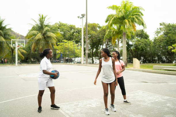 istock Multiracial students practising basketball together 1455705187