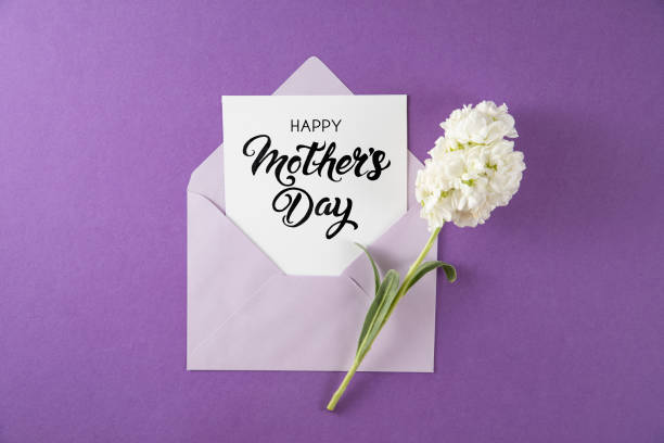 istock White Flowers with White Greeting Card in Purple Envelope 1455706129