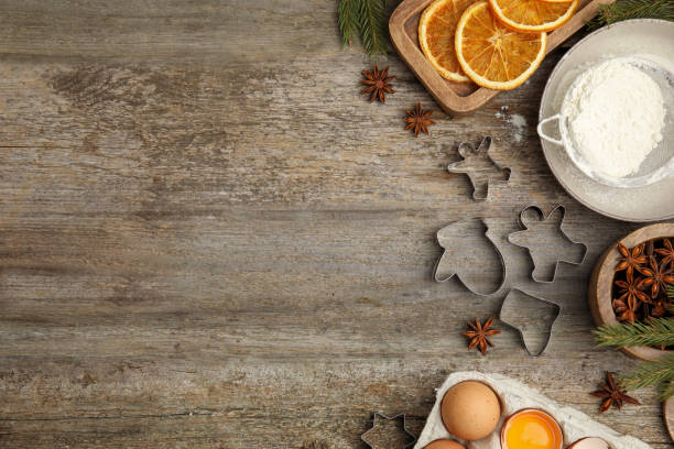 istock Flat lay composition with cookie cutters and ingredients on wooden table, space for text. Christmas biscuits 1455706875