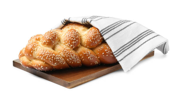 homemade braided bread with sesame seeds and napkin isolated on white. traditional shabbat challah - challah imagens e fotografias de stock