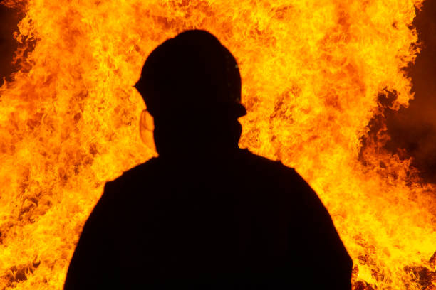 istock Firefighter putting out a fire. Destruction and disaster 1455707004