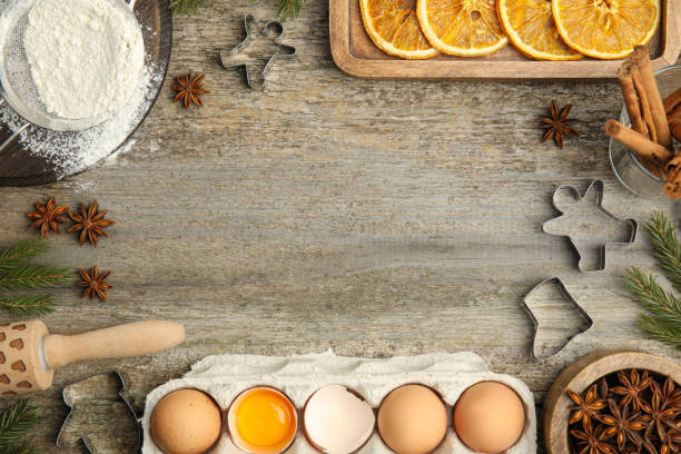 istock Flat lay composition with cookie cutters and ingredients on wooden table, space for text. Christmas biscuits 1455707851