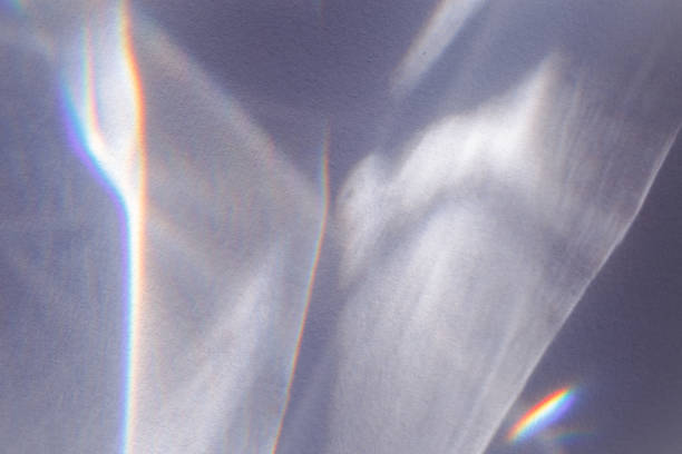 istock Sunlight background, abstract backdrop with light and shadow, glare and shine on paper texture, rainbow sun flare, blue violet color aesthetic image. Natural beams light, caustics effect 1455708095