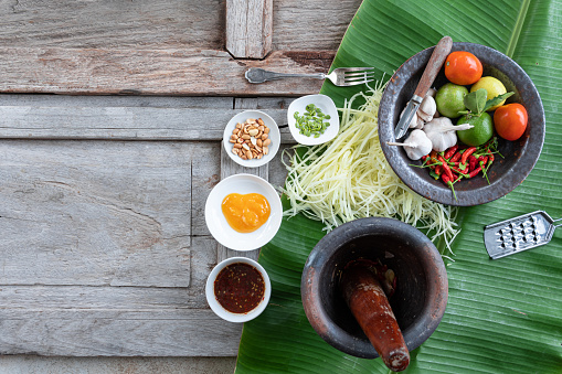 Som Tam Thai -Ingredients Papaya Salad Thai Food Style on wooden table background. Thai Food Concept. Top View