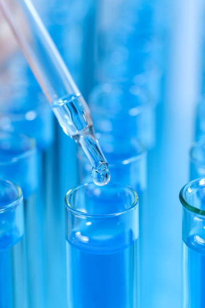 istock Dripping reagent into test tube with blue liquid, closeup. Laboratory analysis 1455709712