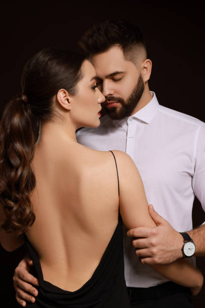istock Handsome bearded man with sexy lady on dark background 1455711311