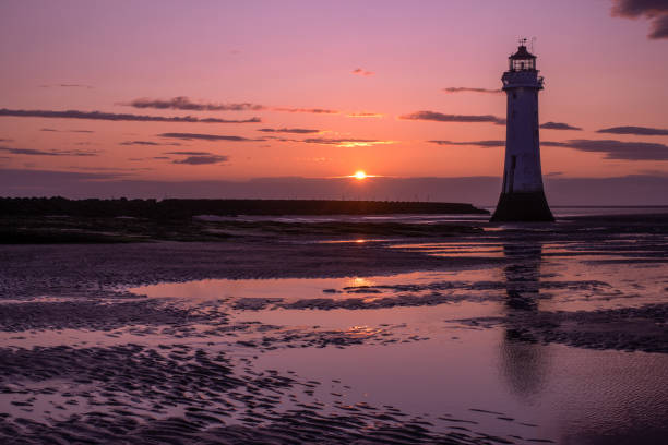 istock Beacon on a beach at sunset or sunrise 1455711370