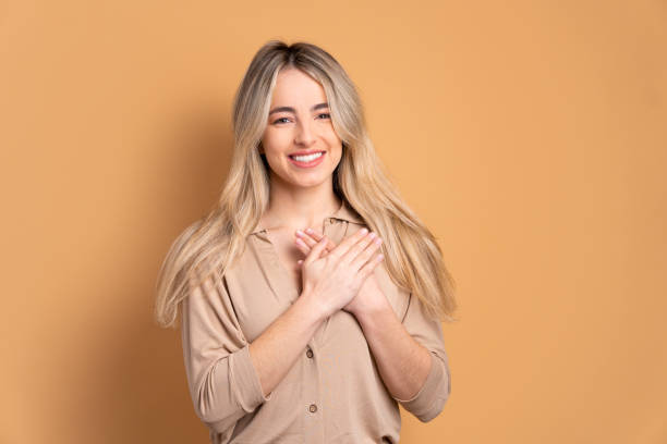 istock woman hands over heart, chest 1455711372