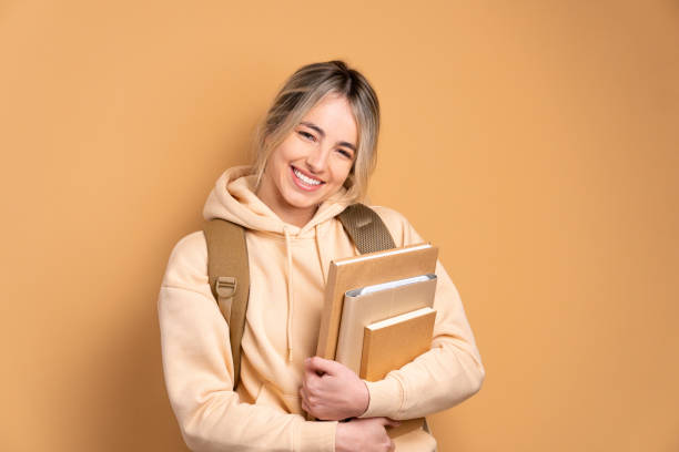 woman holding academy book and smiling