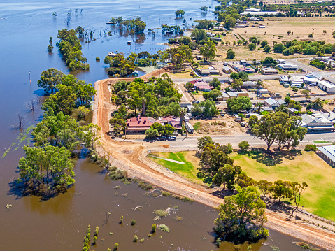 Aerial view, Mypolonga town levee holding back the floodwaters of the River Murray, South Australia.  There’s a staggering amount of water at the end of William street Mypolonga being held back by the temporary town levee built over Hannaford Tce and N Bokara Rd. Flooded properties in top of frame, sports grounds of Mypolonga Primary School in foreground with General Store centre right of frame. Literally 