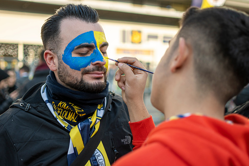 Istanbul, Turkey - January 08, 2023: People enjoying on Kadikoy Square in Istanbul, Turkey. Fenerbahce Sports Club fans having fun together to street before the match.