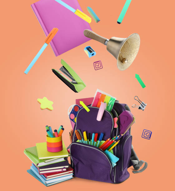 istock Backpack, school bell and different stationery flying on orange background 1455714165