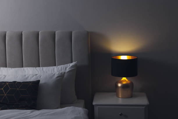 istock Stylish lamp on bedside table indoors. Bedroom interior element 1455714306