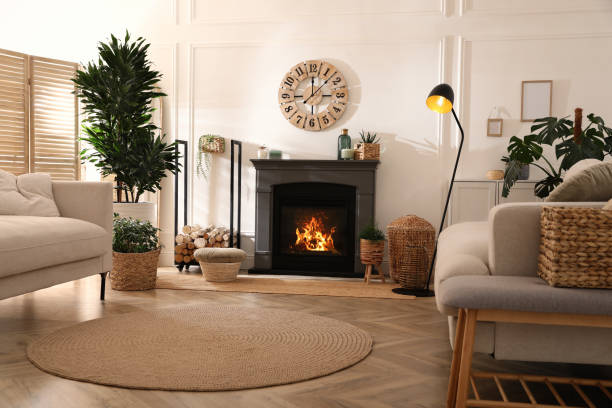 istock Stylish living room interior with electric fireplace, comfortable sofas and beautiful decor elements 1455715073