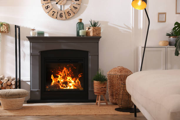 istock Stylish room interior with electric fireplace and beautiful decor elements 1455716003