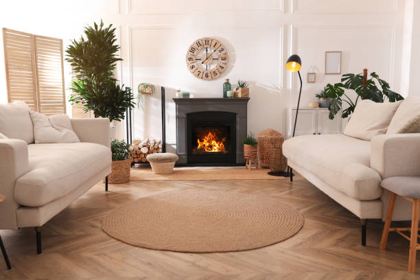 istock Stylish living room interior with electric fireplace, comfortable sofas and beautiful decor elements 1455716506