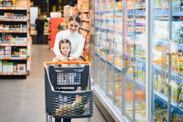 istock Mother with daughter at a grocery store 1455717253