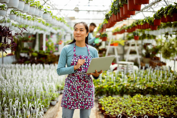 istock Women Gardener Using Laptop 1455717343