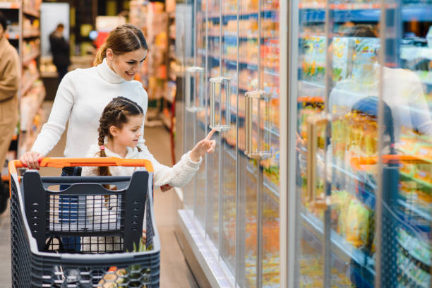 istock Mother with daughter at a grocery store 1455717550