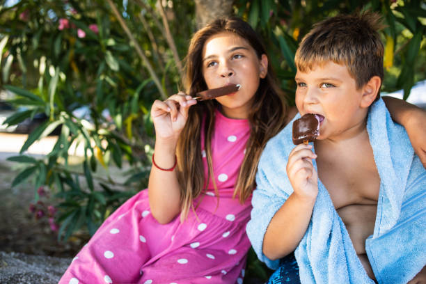 istock Cute kids eatig ice cream 1455718636
