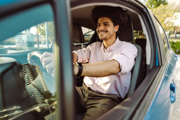istock Young man driving a car with pleasure 1455720180