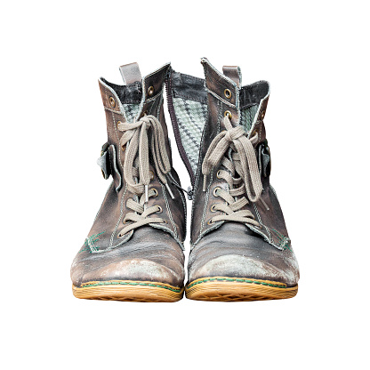 A pair of worn, vintage styled, classic sneakers isolated on white background. File contains clipping path.