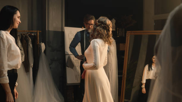 istock Tailor zips up wedding dress on woman 1455722077