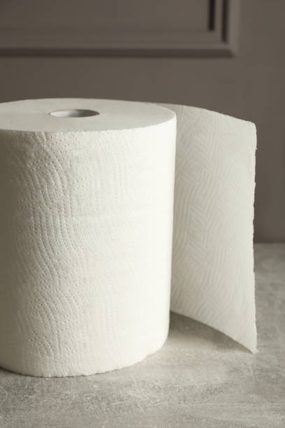 istock Roll of white paper towels on grey table 1455725071