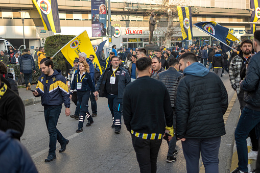 Istanbul, Turkey - January 08, 2023: People enjoying on Kadikoy Square in Istanbul, Turkey. Fenerbahce Sports Club fans having fun together to street before the match.